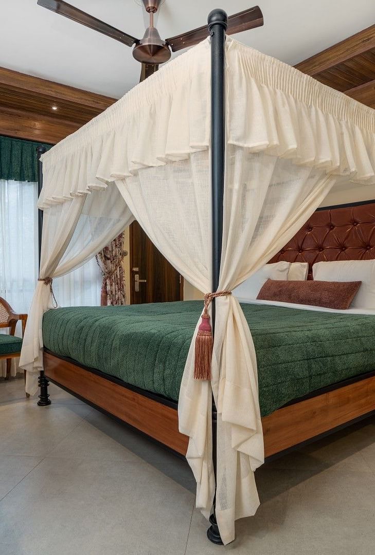 A large bed with good lighting, plus wooden furniture