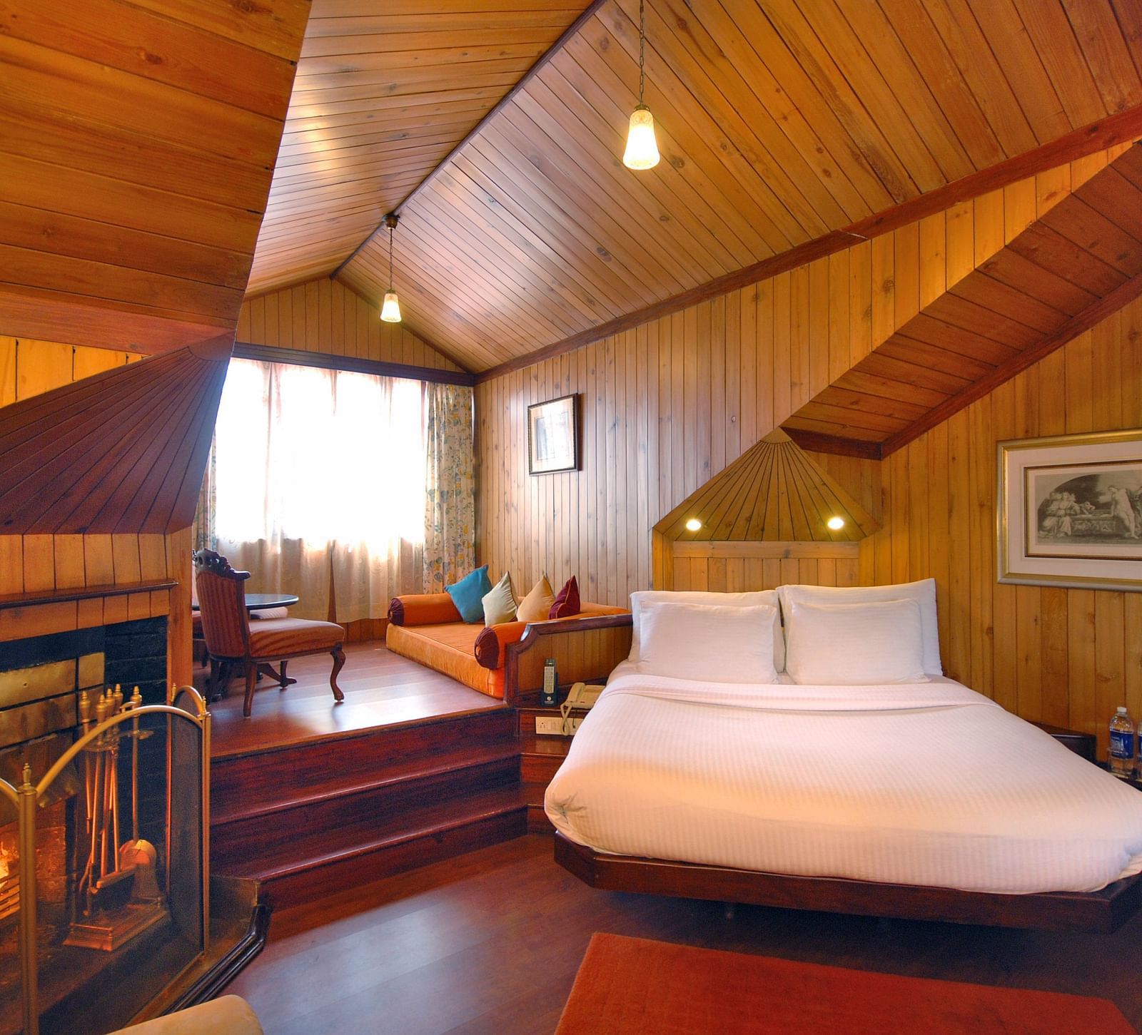 a king size bed and a fireplace to the left - Mayfair Hill Resort, Darjeeling