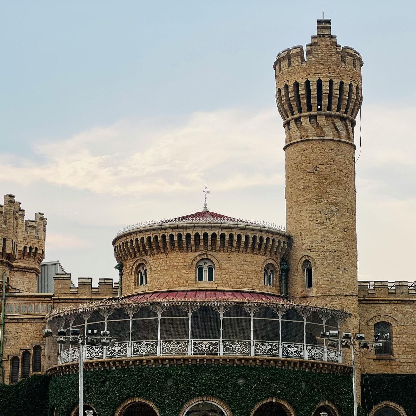 A majestic view of a historic castle-like structure with a prominent tower, showcasing its grandeur and architectural style.