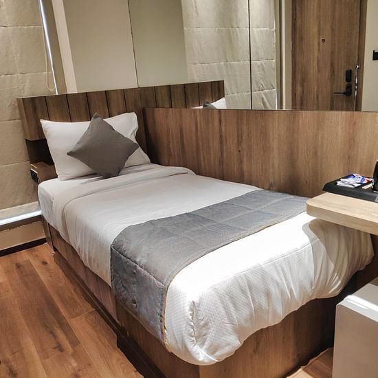 Economy Room with single bed and wooden interiors at Maxxvalue Hotel MIDC,  Mumbai