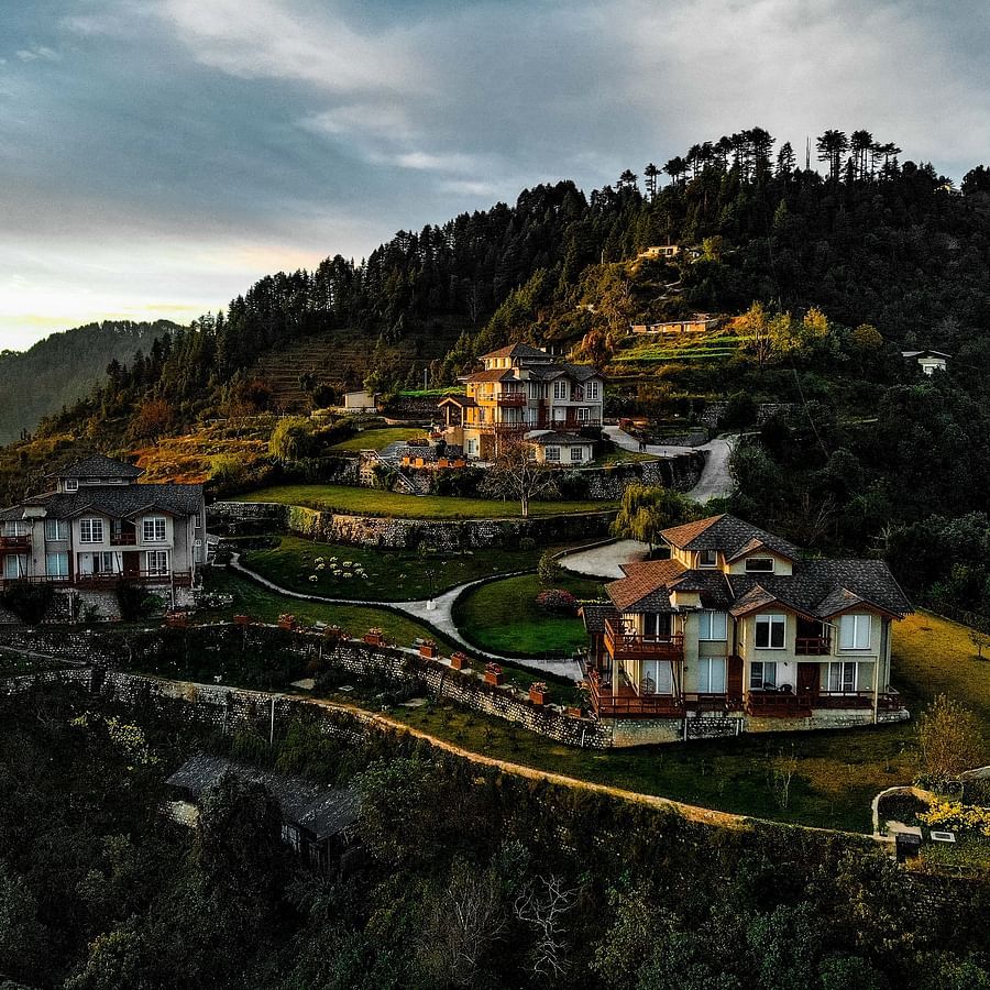 a bunch of cottages nestled on the top of a hill