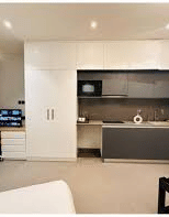Spacious room with kitchenette and work desk at Turmeric Stays by Lime Tree Hotel, Greater Noida.