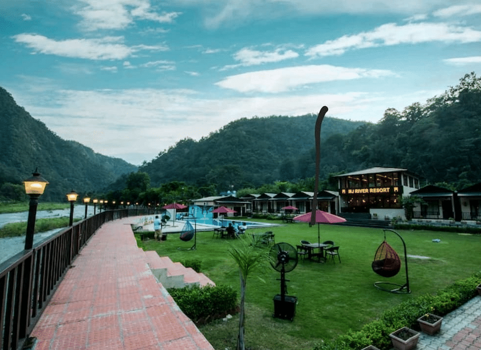 A far-angle view of DLS MJ River Resort, Rishikesh with a garden view .
