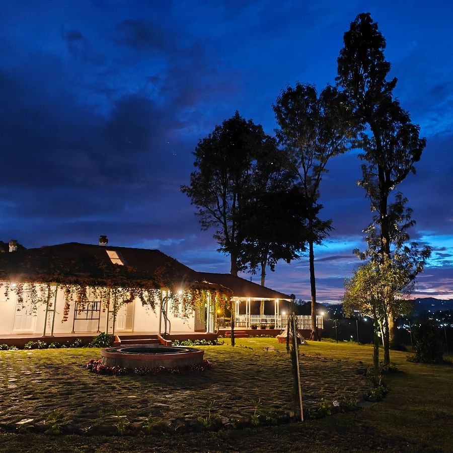 Facade image of Ibex Stays & Trails, Coonoor (Leewood) during twilight with the lights on.