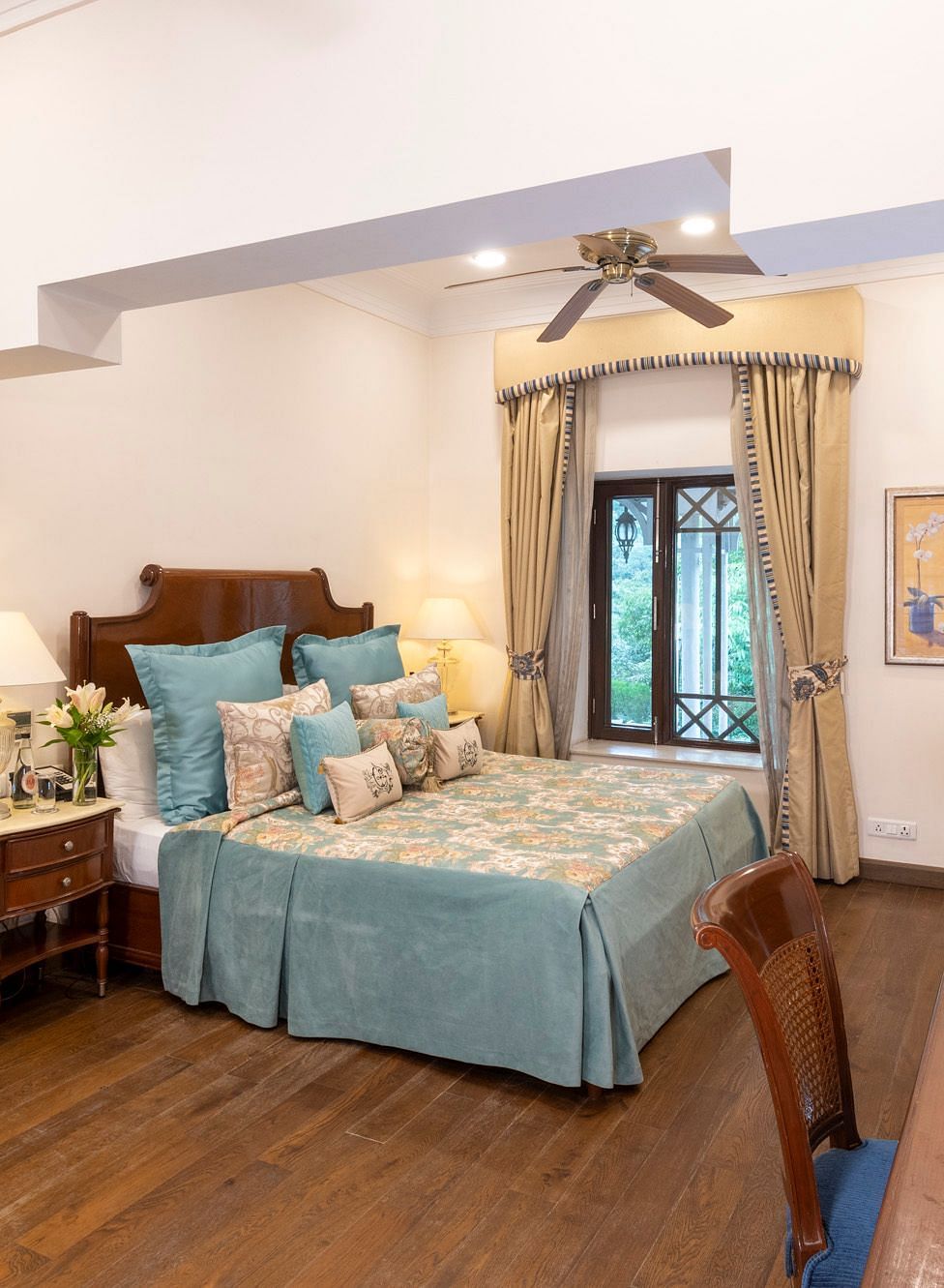 view of the deluxe room with king sized bed and a mirror and a workspace at the Claridges Nabha Residence, Mussoorie