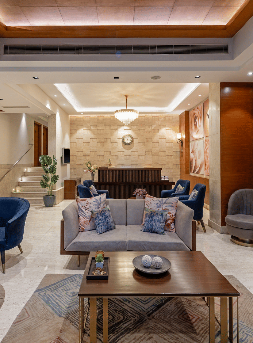 Spacious and luxurious hotel lobby of Hotel Saket 27 featuring modern seating arrangements, ambient warm lighting, stylish décor, and a welcoming atmosphere for guests
