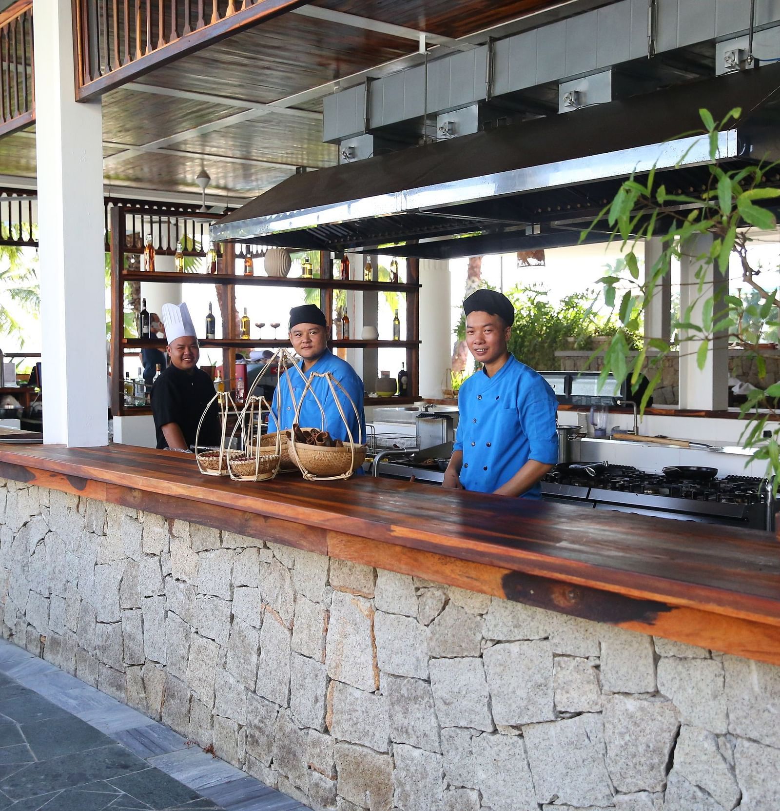 A counter in our restaurant with two attenders standing in blue uniforms behind the counter - Alibu Resort Nha Trang