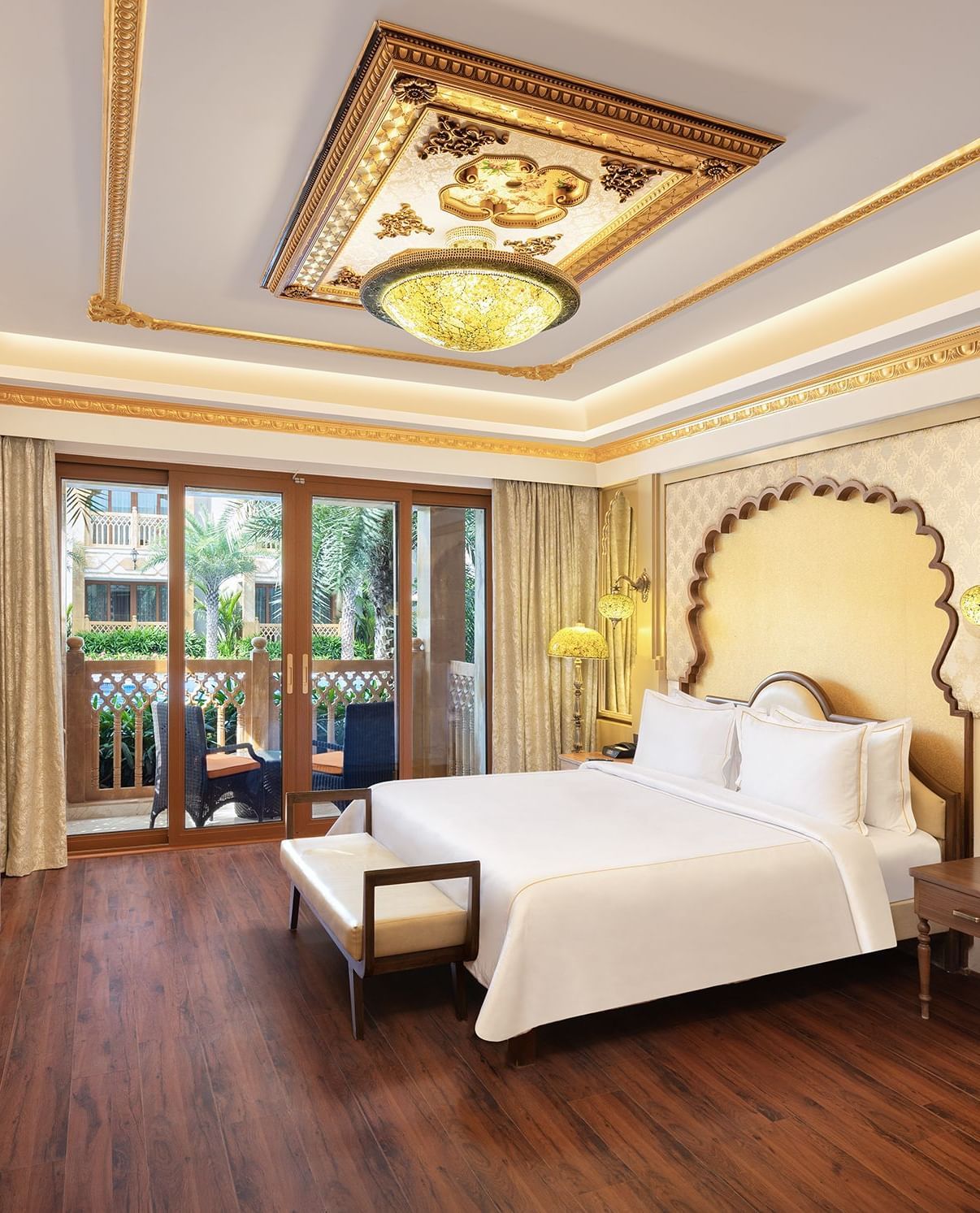 An elegant bedroom with a canopy-styled headboard and artistic wall panelling – Kaldan Samudra, one of the finest Mahabalipuram resorts with private beach