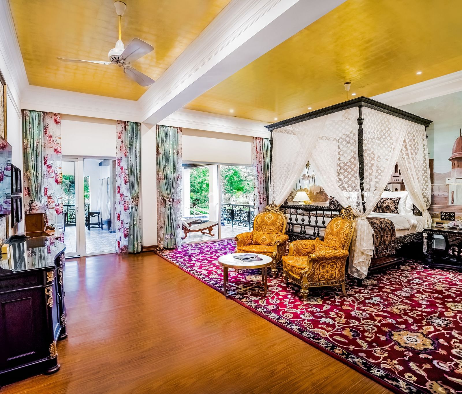 two chairs kept in front of a king size facing a wooden cabinet - Mayfair Tea Resort, Siliguri 