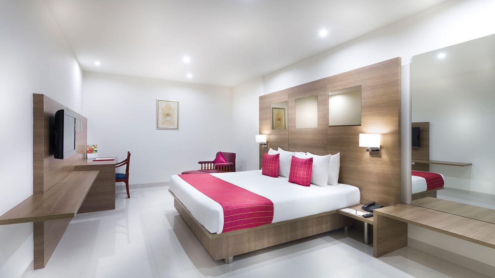 An image of a king size bed of a Deluxe Room at Regency Tiruttani by GRT Hotels.