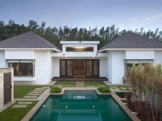 private pool at The Residence with small plants growing on one side and stone pathway on the other at The Serai, Chikmagalur - The Best Place to Stay in Chikmagalur for Couples.