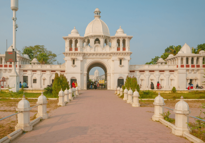 A grand palace entrance with domed gateways and landscaped grounds - Polo Hotel Agartala