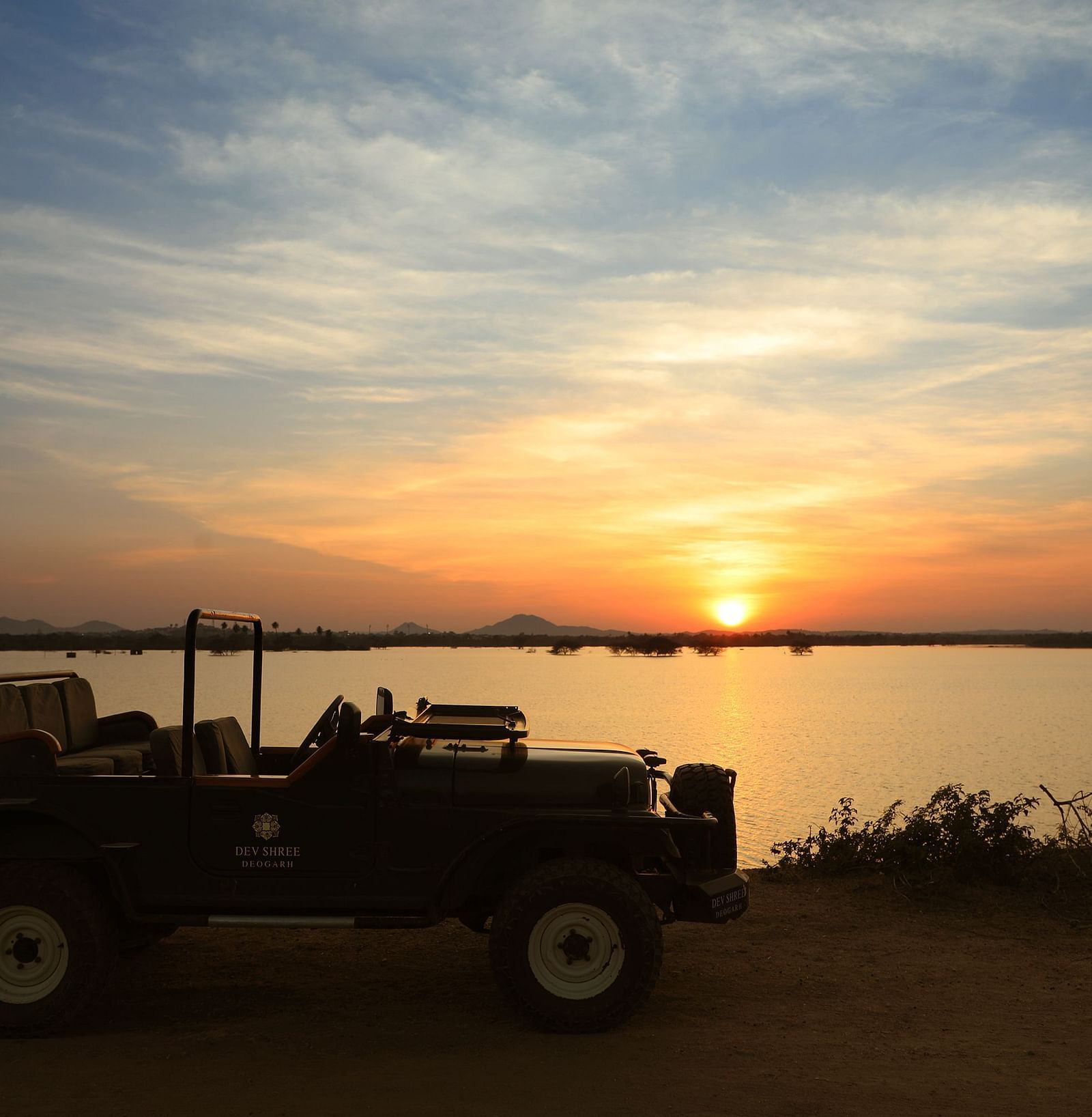 an image of a jeep with a beautiful sunset background at dev shree, deogarh