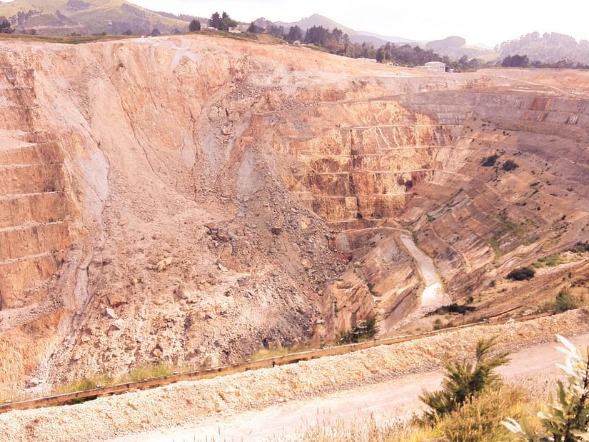 An overview of a place that has been mined for minerals with layers showing on the earth.