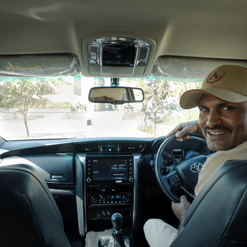 Image of the Interiors of the a Car Along With the Driver