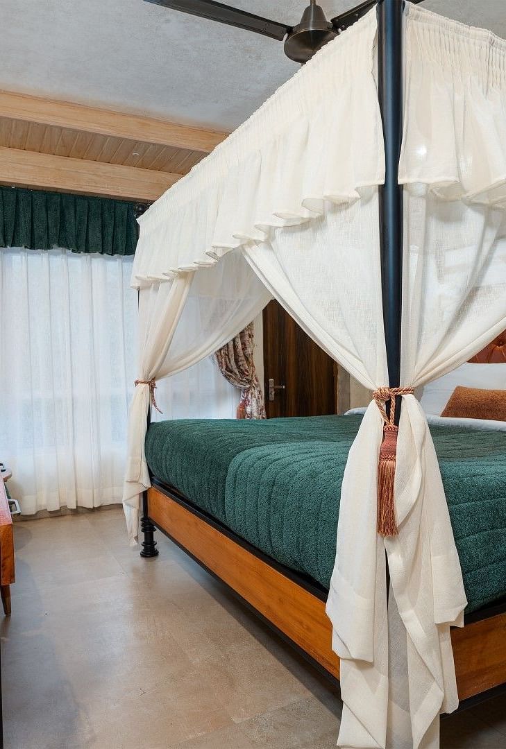 Deluxe room featuring a large bed and wooden furniture accents