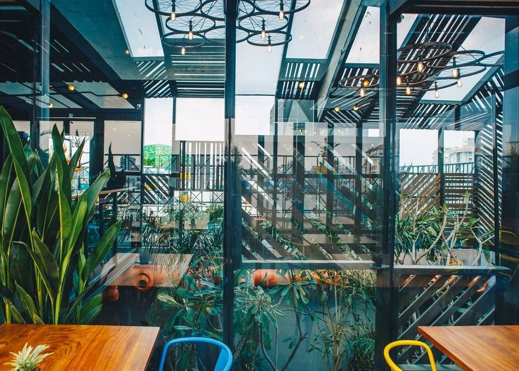 The huge glass partition between the indoor and outdoor seating area reflecting the beautiful sky.
