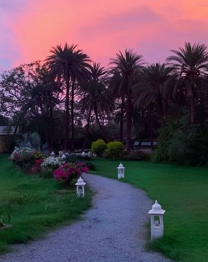 image of the Garden area at Dev Shree, deogarh during the Sunset with beautiful pink and lavender hues in the background