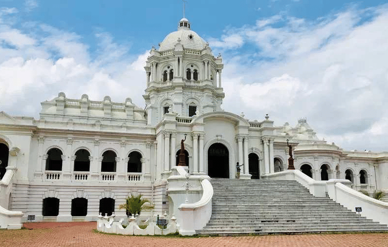 A wide shot of two-story white Ujjayanta Palace in Agartala.