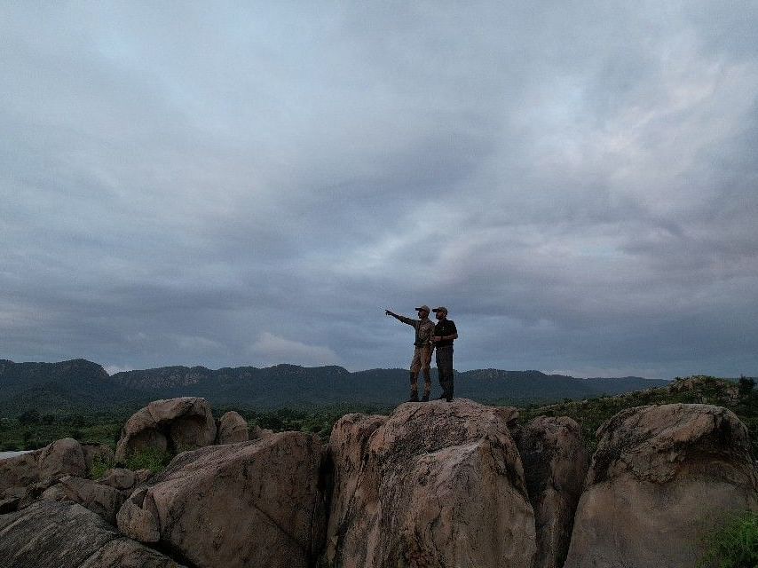 Image of two people standing on boulders during Wilderness walk - Utsav Camp sariska