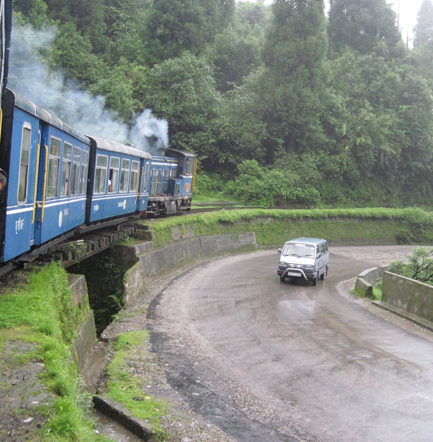 a passenger looking out from the window of a toy train in Darjeeling