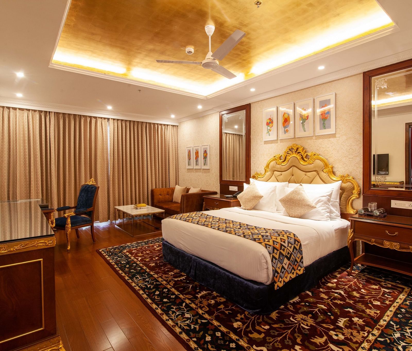 a king size bed facing the TV at one of the rooms - Mayfair Lake Resort, Raipur 