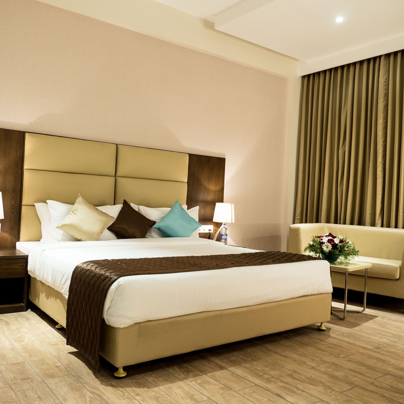 A large bed in Premium Room at Grand Ashok, Thanjavur.
