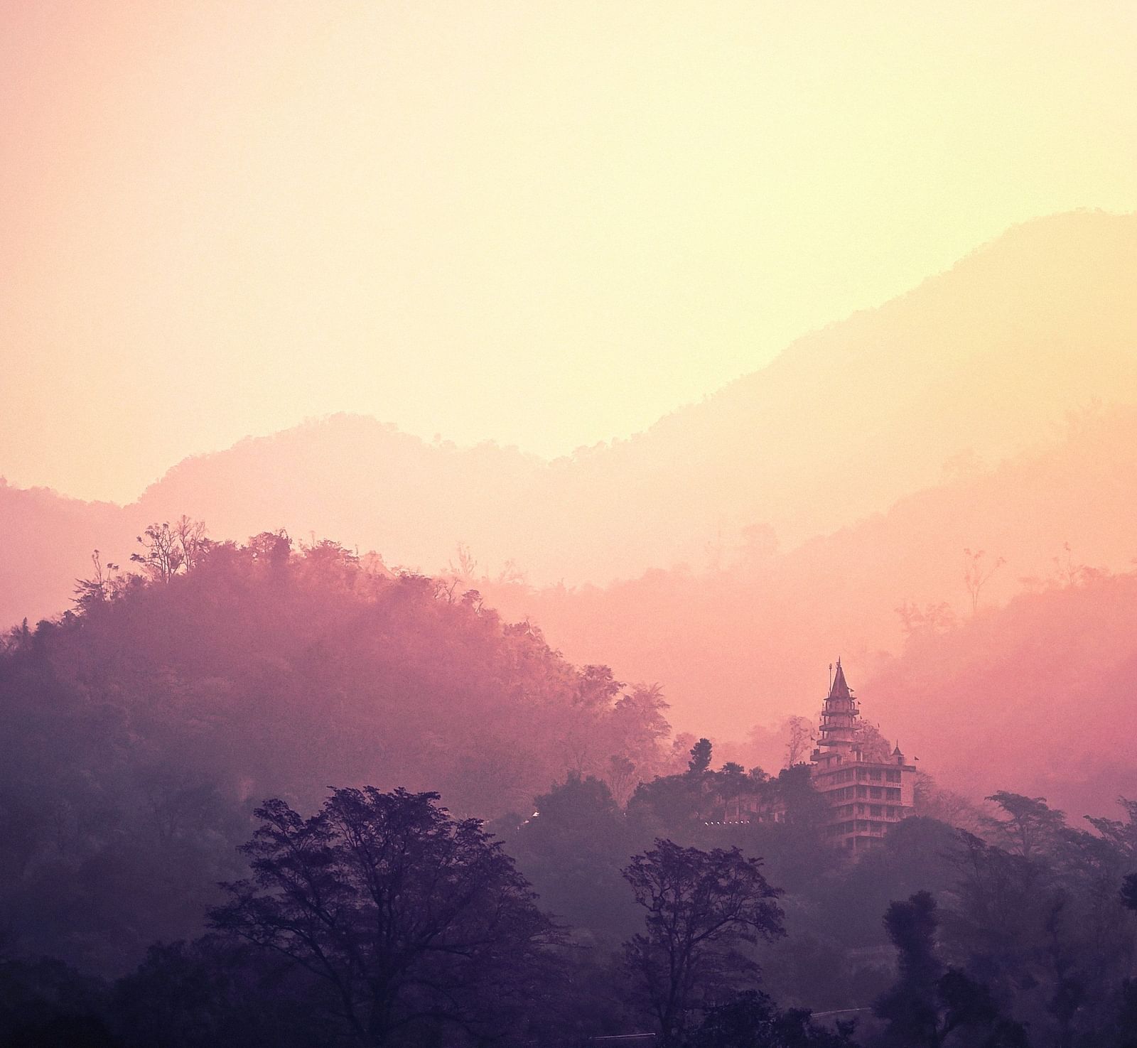 image of mountain ranges with a lot of fog and mist in the air