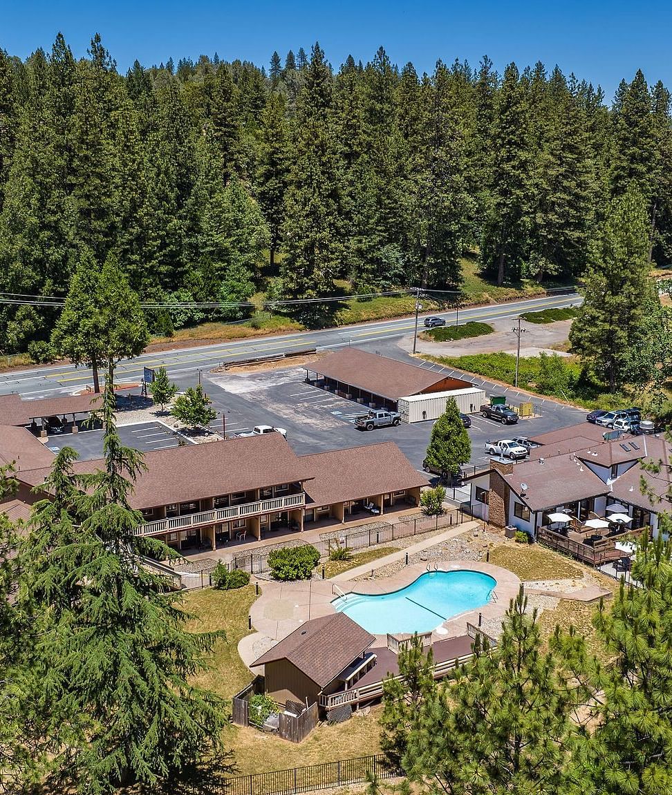 Aerial view of Narrow Gauge Inn surrounded by forests during the day.