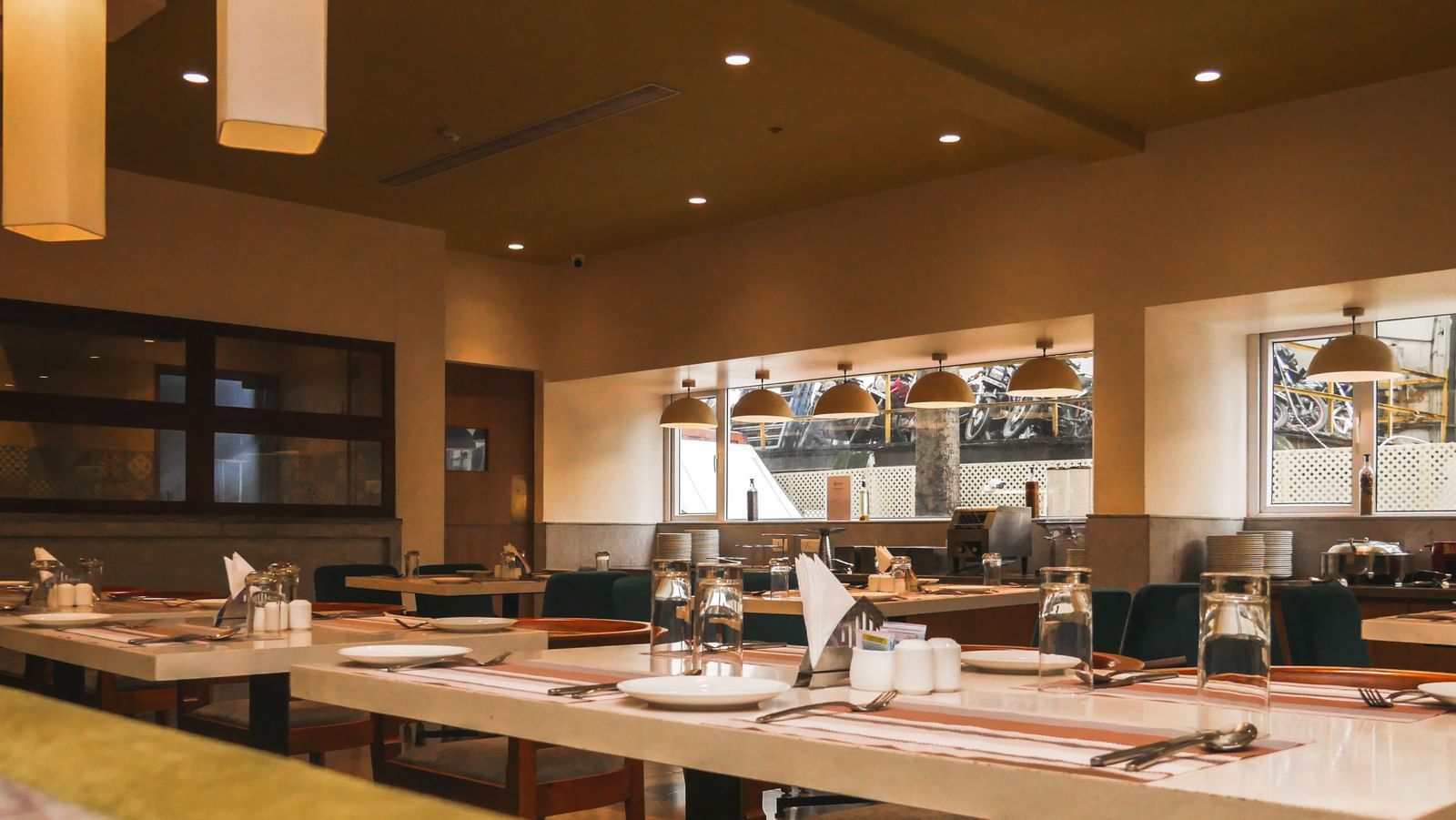A contemporary restaurant space with tables set for dining and soft ambient lighting at Shilton Dee Cee.