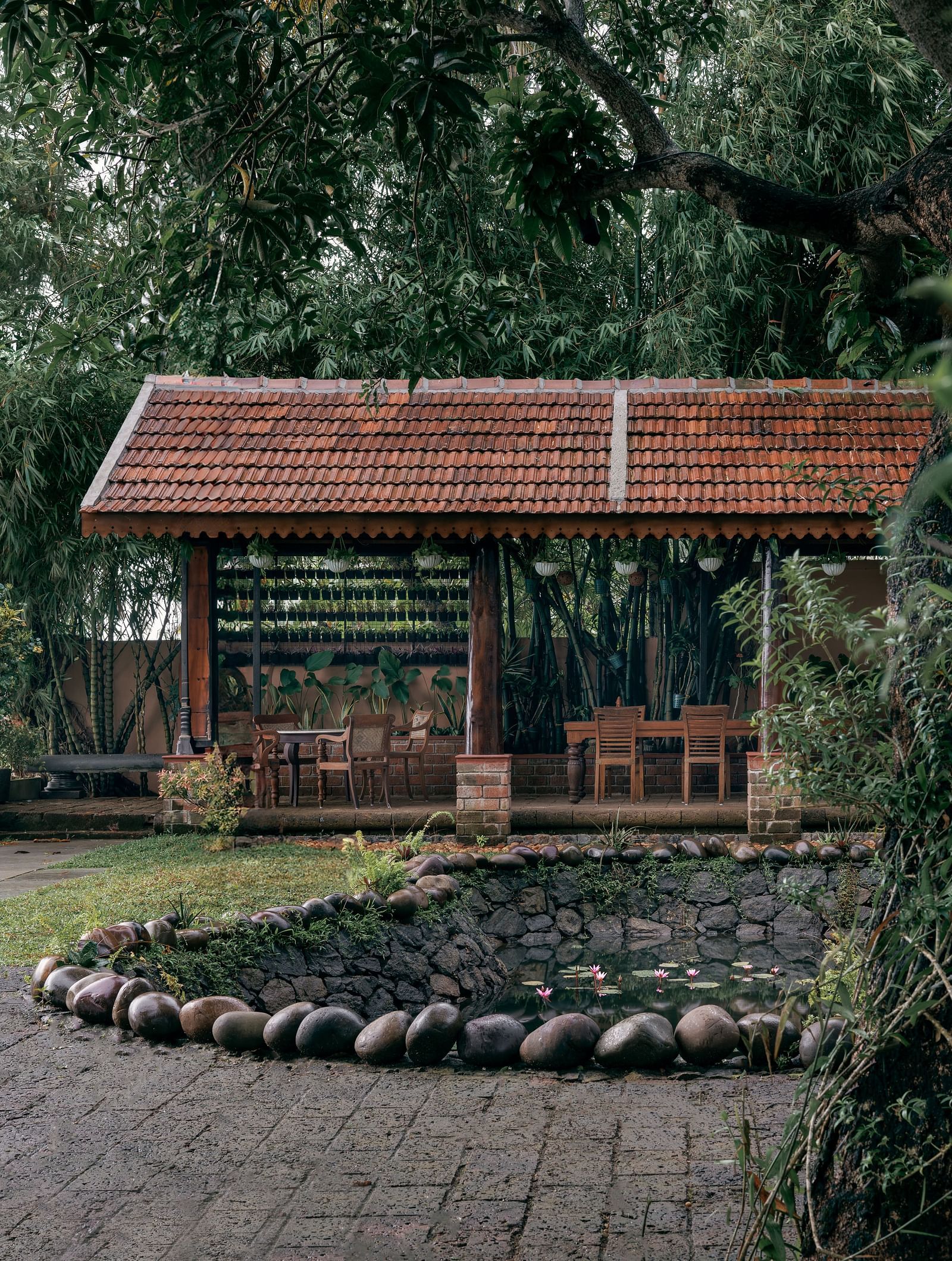 A facade image showcasing the pond at BluSalzz Villas - Muhamma Resort, Alleppey and the outdoor seating area of the restaurant