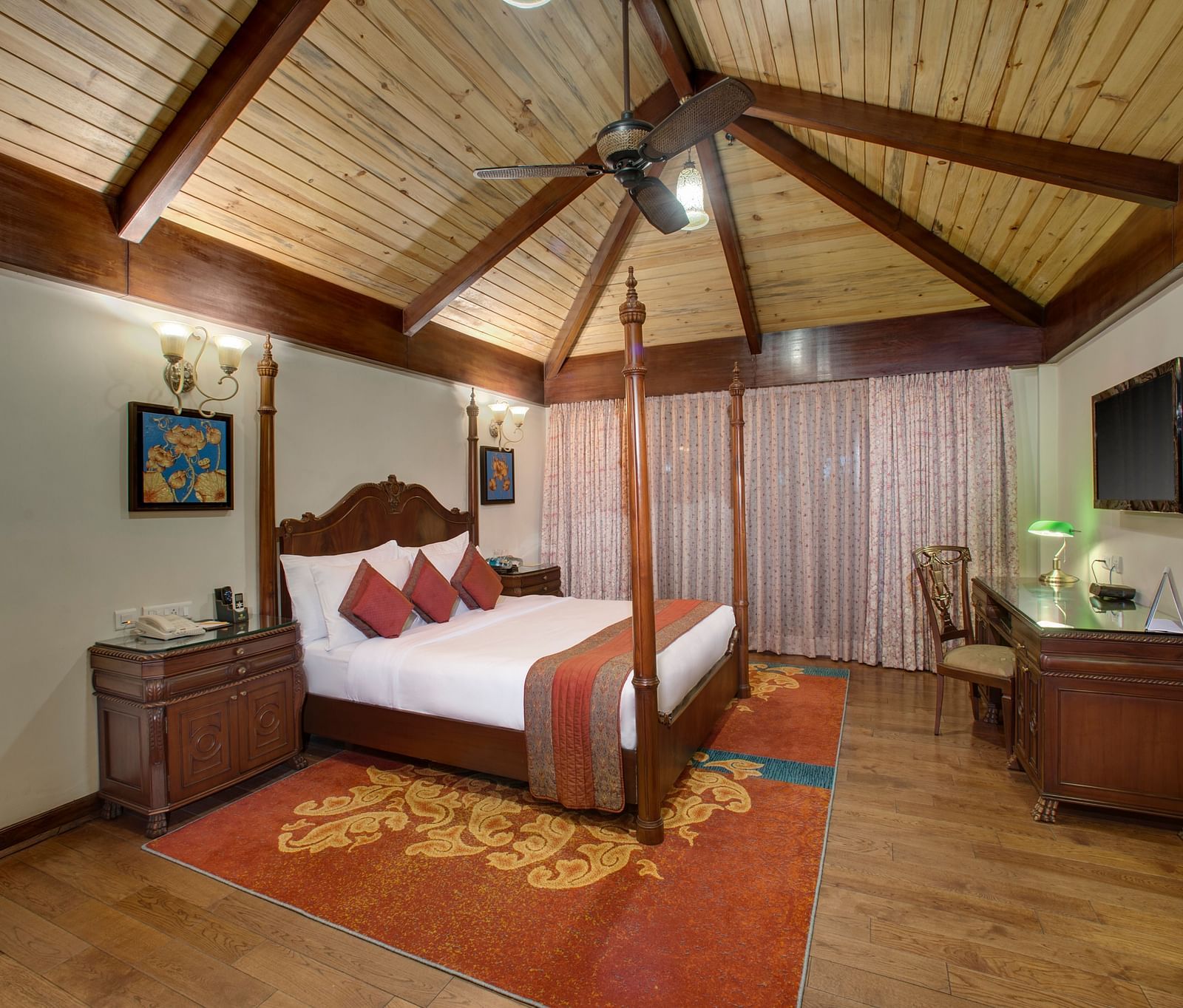 a king size bed facing a TV - Mayfair Spa Resort & Casino Gangtok 