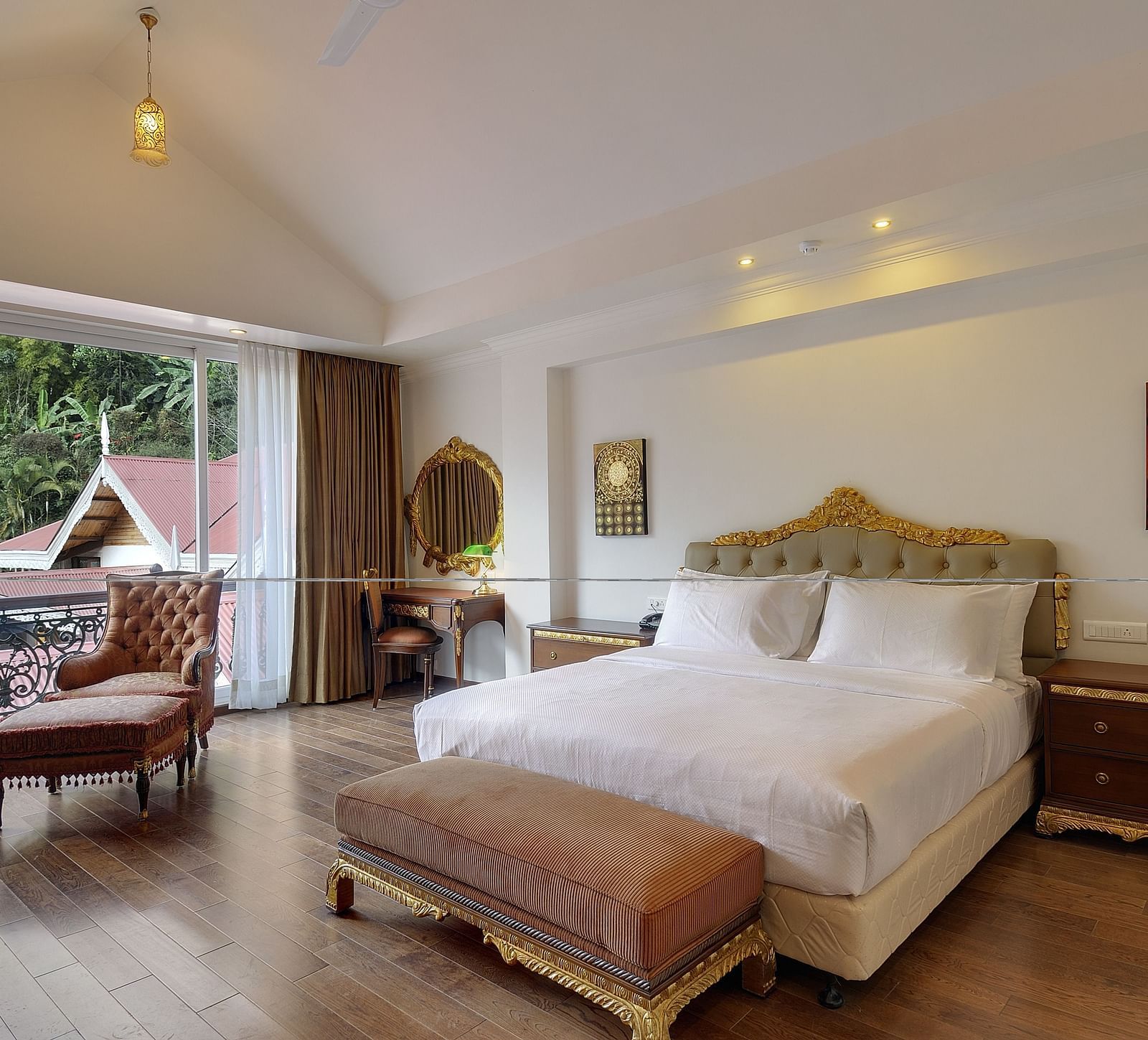 a king size bed and a sofa by the window - Mayfair Spa Resort & Casino Gangtok