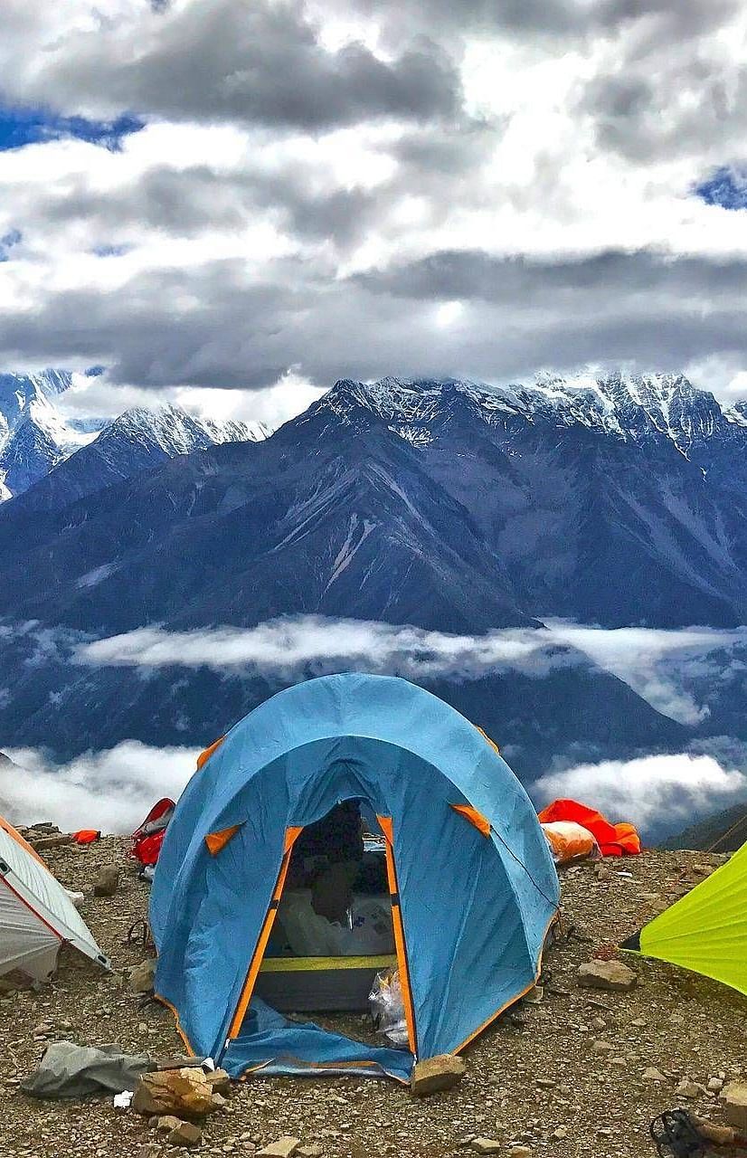 camping tents overlooking snow-capped mountains