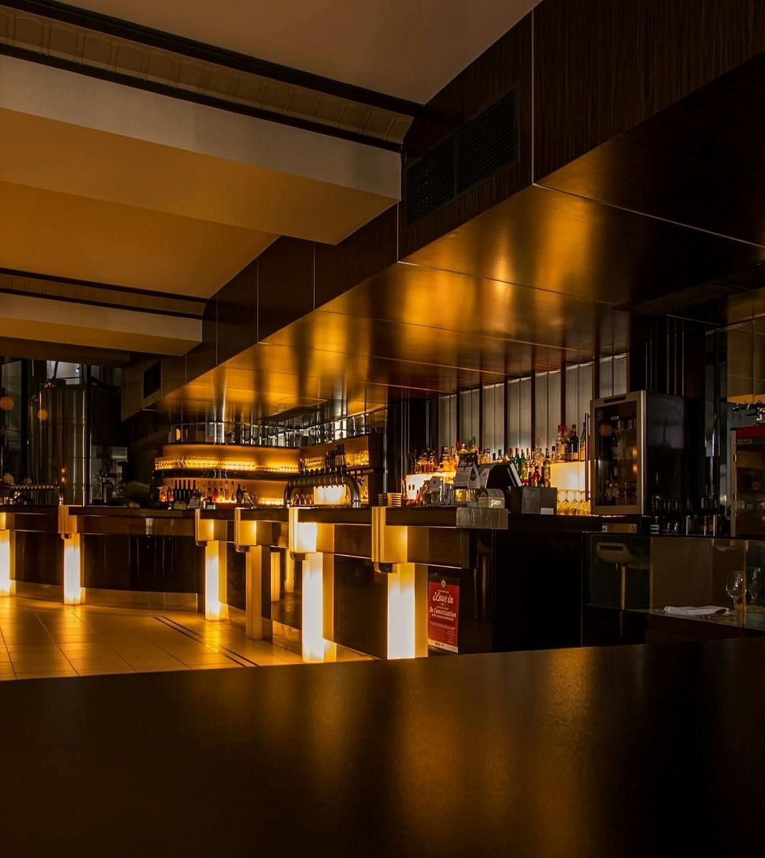 An empty restaurant at night with the lights on.