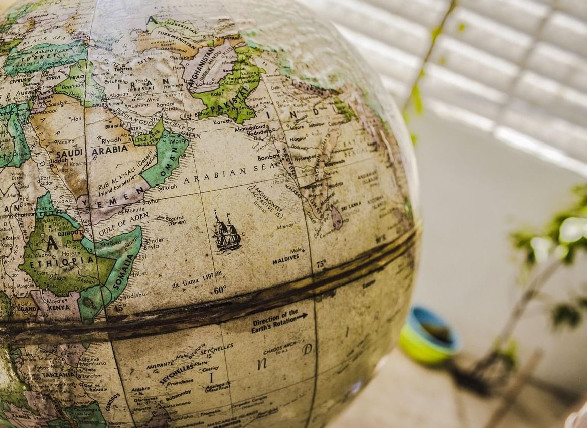 A part of a globe featuring the topography of India and other western regions.