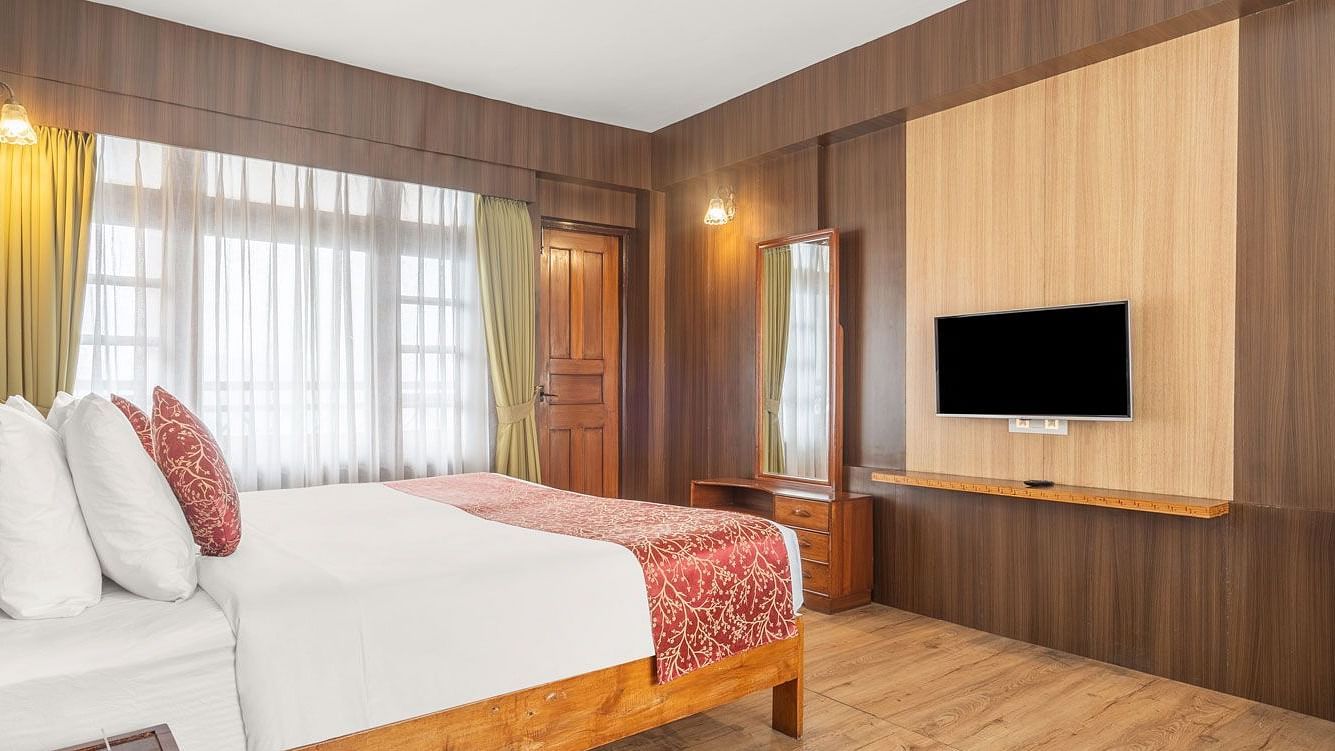 Image of a room with bed and television in front at at Summit Tashi Ghang Heritage Resort, Pelling