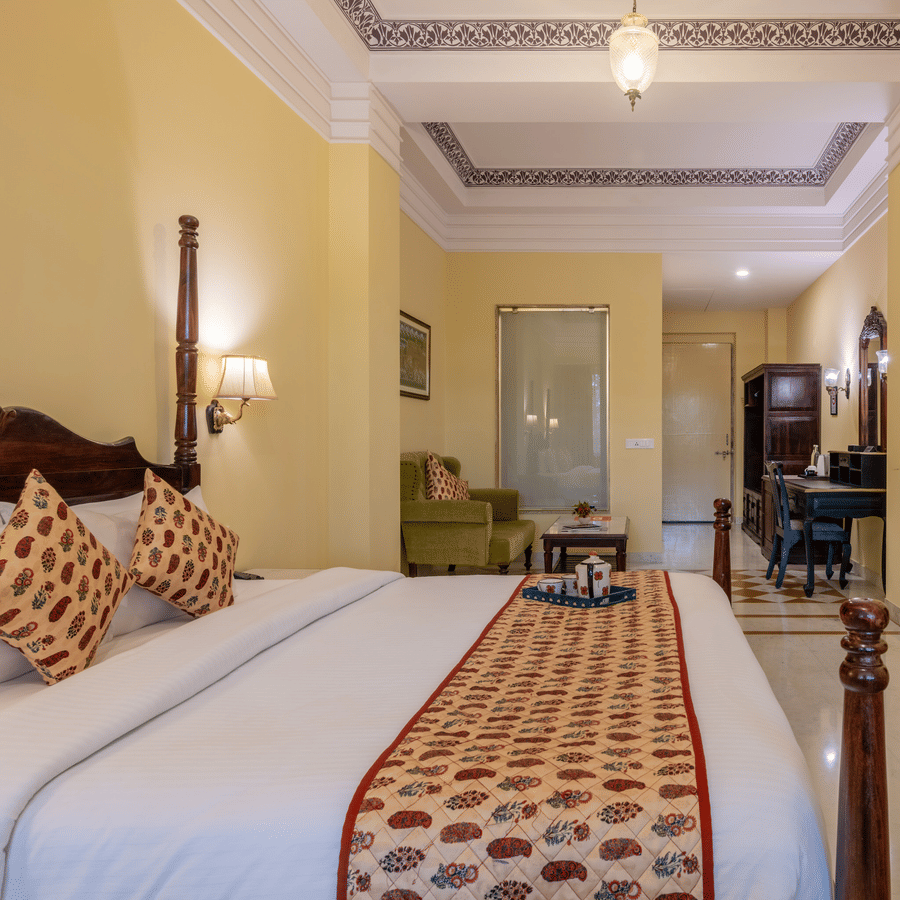 A spacious, traditional guest room at Umaid Palace, providing a comfortable and royal stay near Delhi.