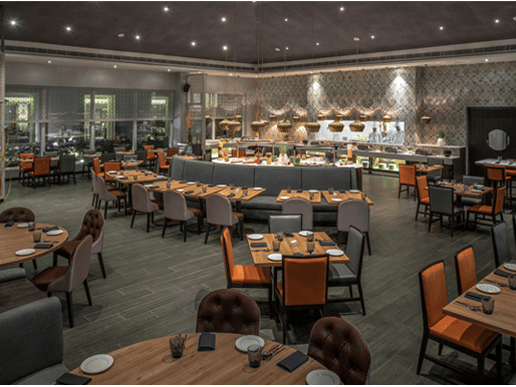 Restaurant at The Residency Towers Rameswaram featuring dining tables and chairs