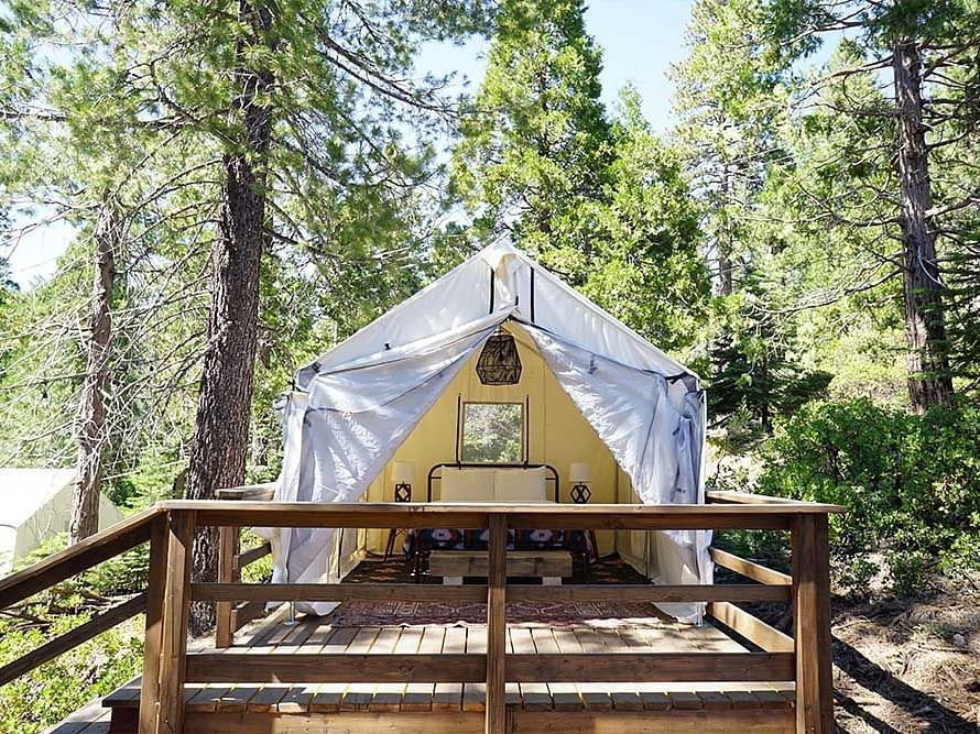 Exterior of a tent surrounded by trees at Shaver Lake Village Hotel.