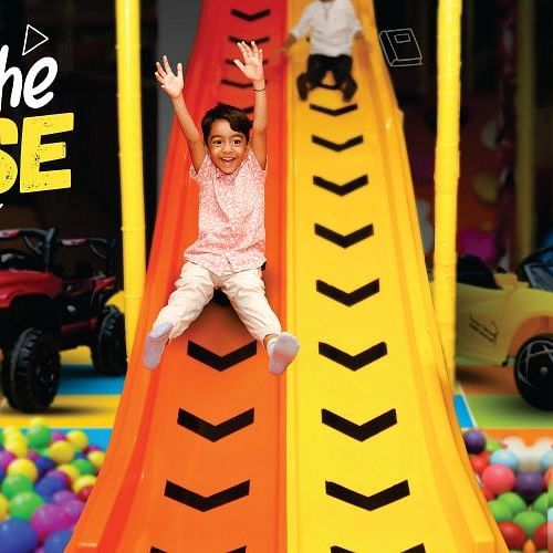 Kids enjoying a ball pit at a theme park under colorful banners | Diamond Parks, Pune 