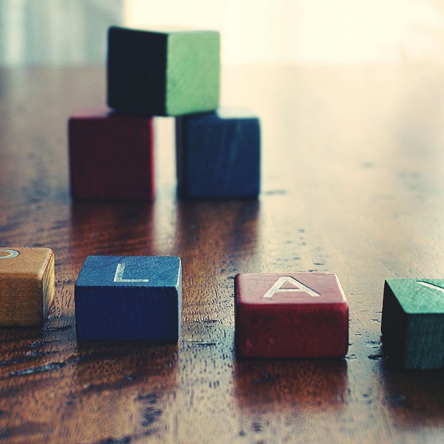 Image of blocks on a table that reads Play.