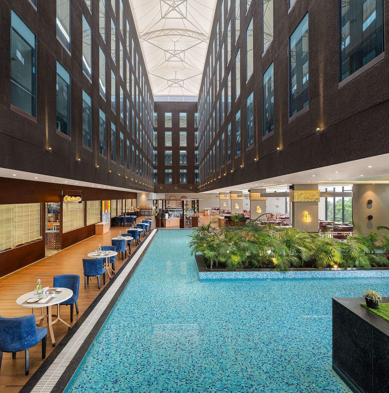 Blue Salt Cafe at Essentia Luxury Hotel, Indore with poolside seating arrangement