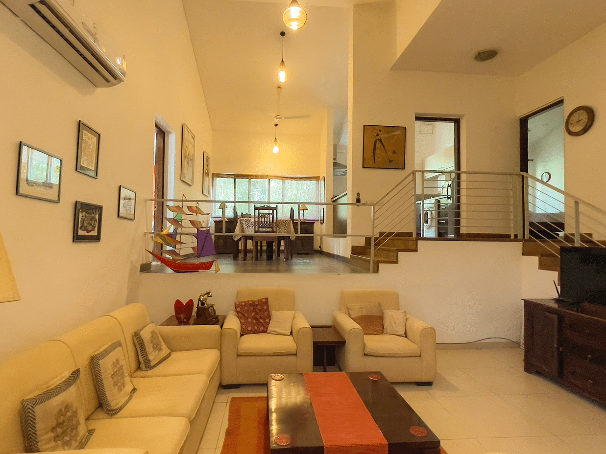 Sofas in the ground floor with dining table in the first at el benito goa