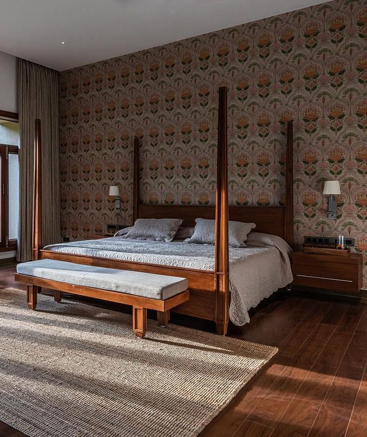 A bedroom with a four-poster bed, large windows, and a brick wall, modern design - Shreyas Retreat