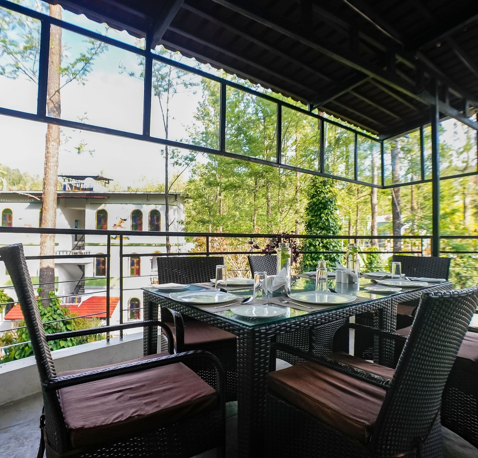 Close-up view of dining area with chairs arranged around the table at WOW Bungalow, Yercaud.
