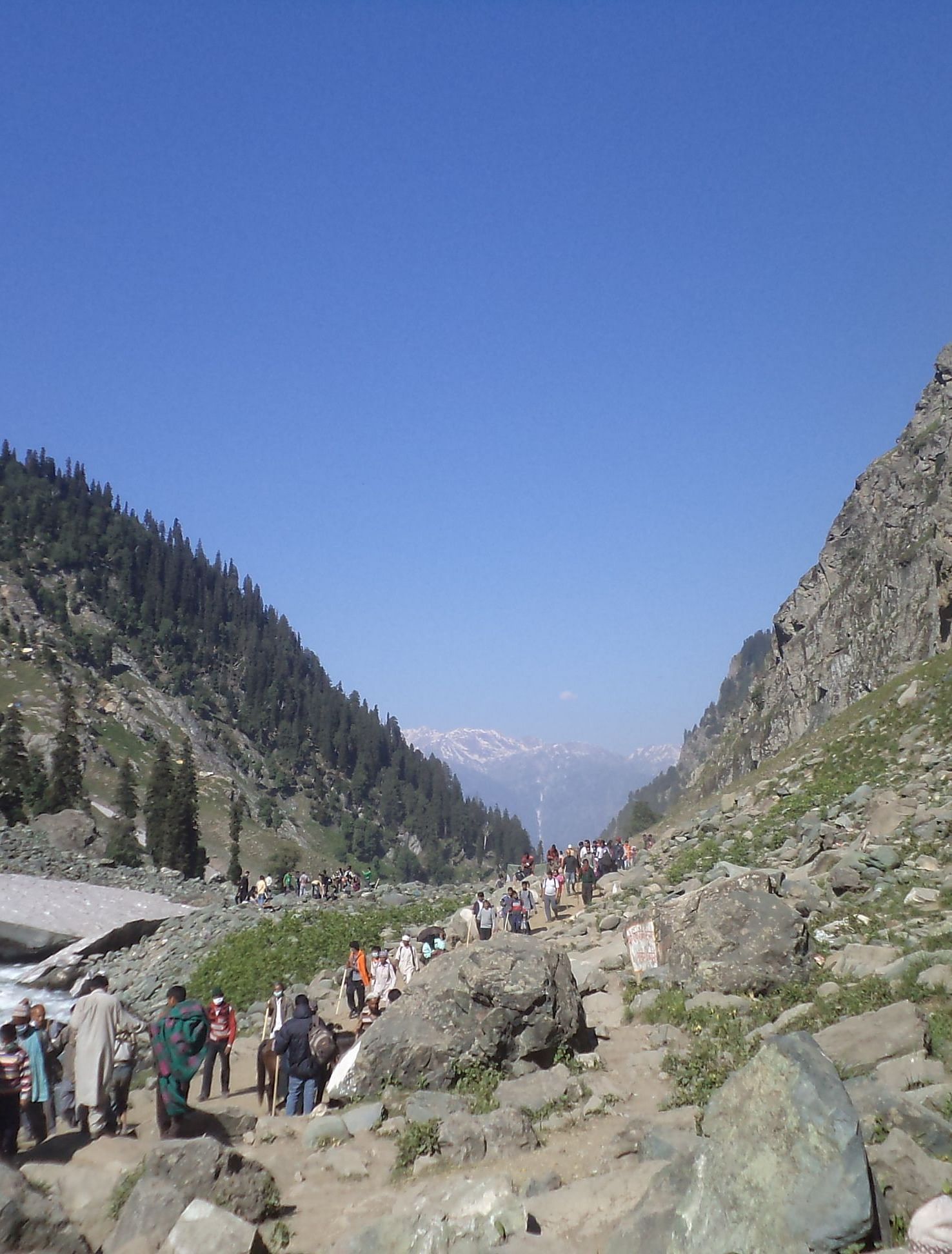 image of a lot of people trekking amidst the stony valleys in a mountain range