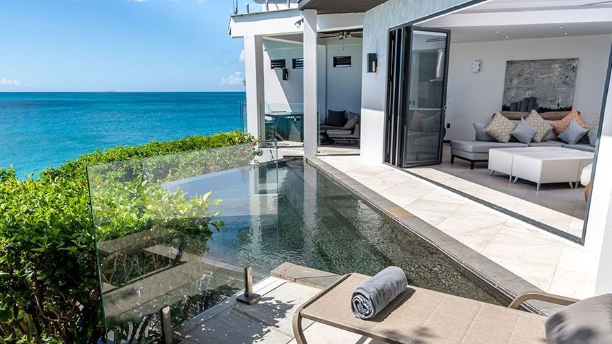 Luxury oceanfront villa with private plunge pool at Tamarind Hills Resort and Villas, Antigua overlooking the Caribbean Sea.