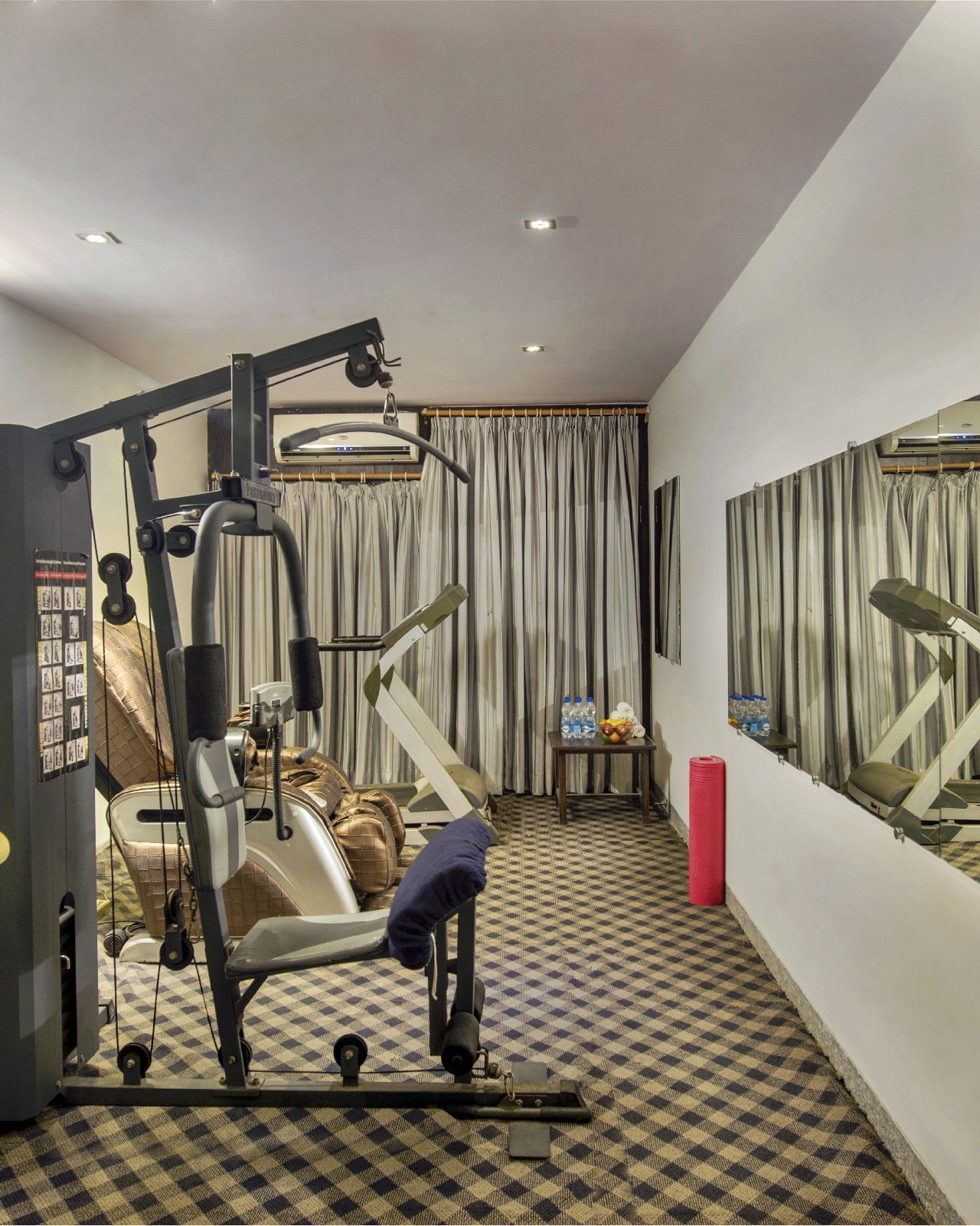 Fully equipped fitness centre at Lords Eco Inn Dahej featuring cardio and strength training equipment.