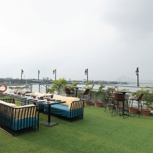 view of the seating area at the outside deck - Polo Floatel Kolkata
